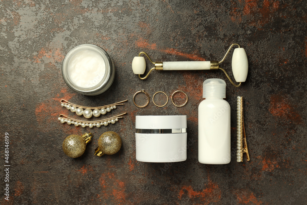 Composition with winter cosmetic products on textured background, top view