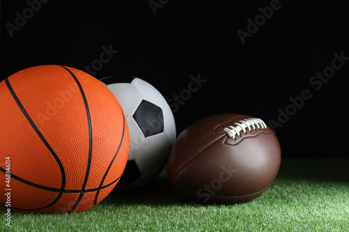 Set of different sport balls on green grass