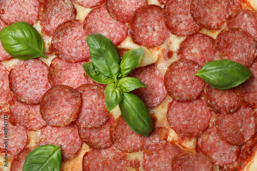 Salami pizza all over background, close up