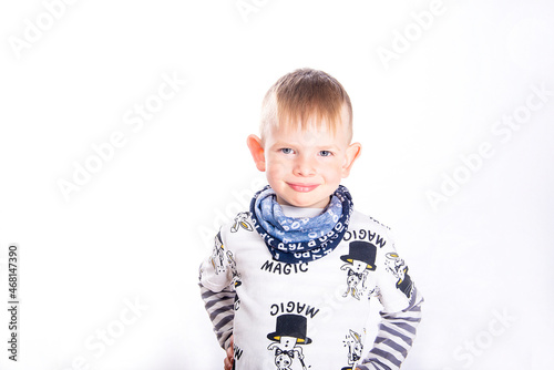 Close-up portrait of cute smiling little boy face with blue eyes and big ears isolated on white background