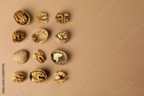 Flat lay composition with walnuts on brown background