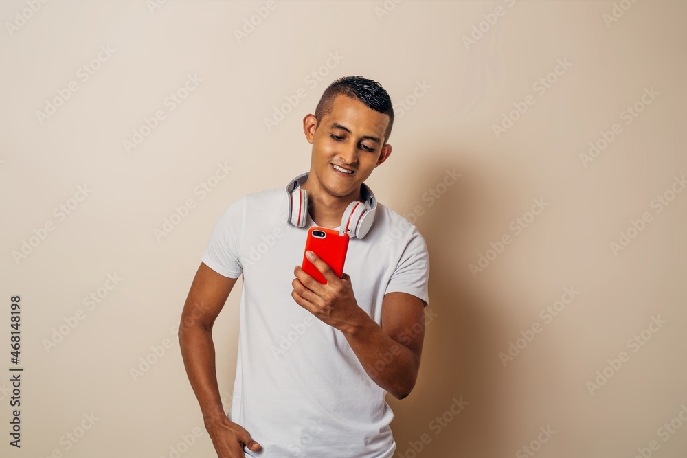 Student latin american man using a smartphone. Student latin american man using a smartphone.