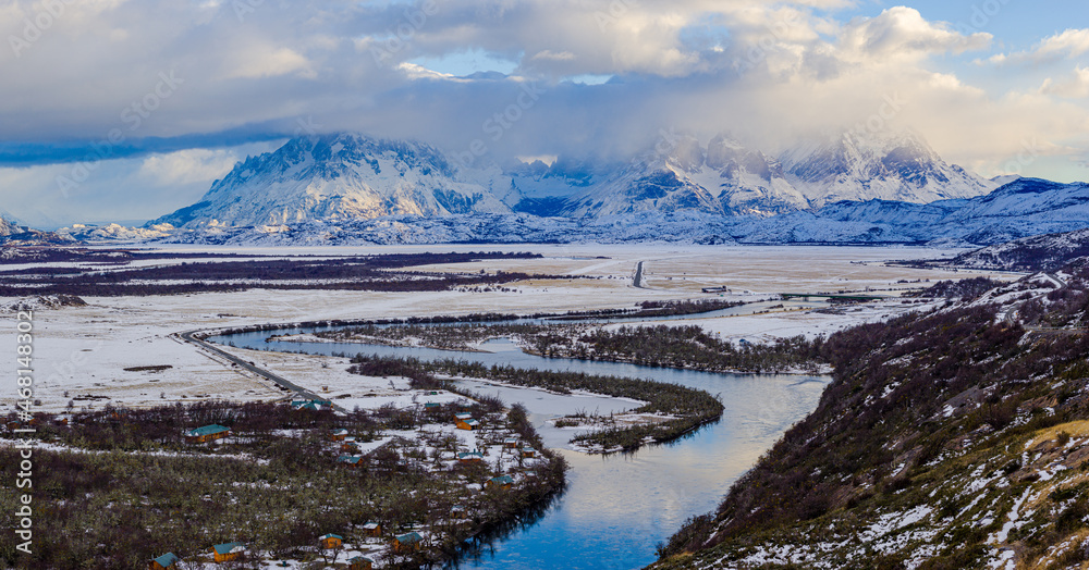 Winter in Patagonia: cloudscape over the iconic Paine mountain range and the river Rio Serrano, Torres del Paine National Park, Chile