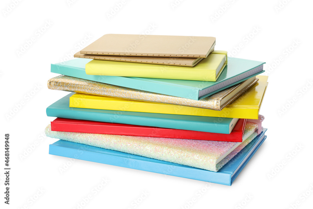 Stack of different colorful hardcover planners on white background Stack of different colorful hardcover planners on white background