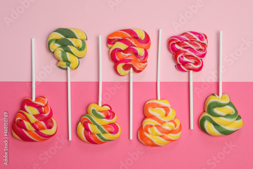 Sweet lollipops on color background, flat lay