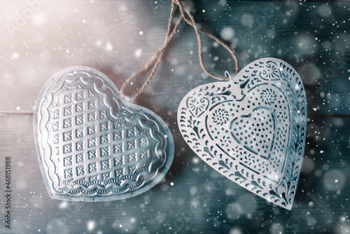 Two christmas decoratoin hearts with snowfall photo