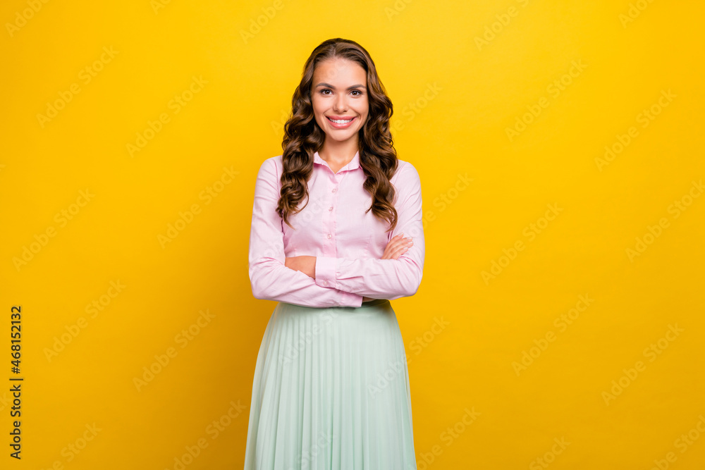 Photo of confident millennial brunette lady crossed arms wear pink shirt skirt isolated on yellow color background Photo of confident millennial brunette lady crossed arms wear pink shirt skirt isolated on yellow color background