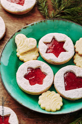 Classic Linzer Christmas Cookies with raspberry or strawberry jam on wooden table photo