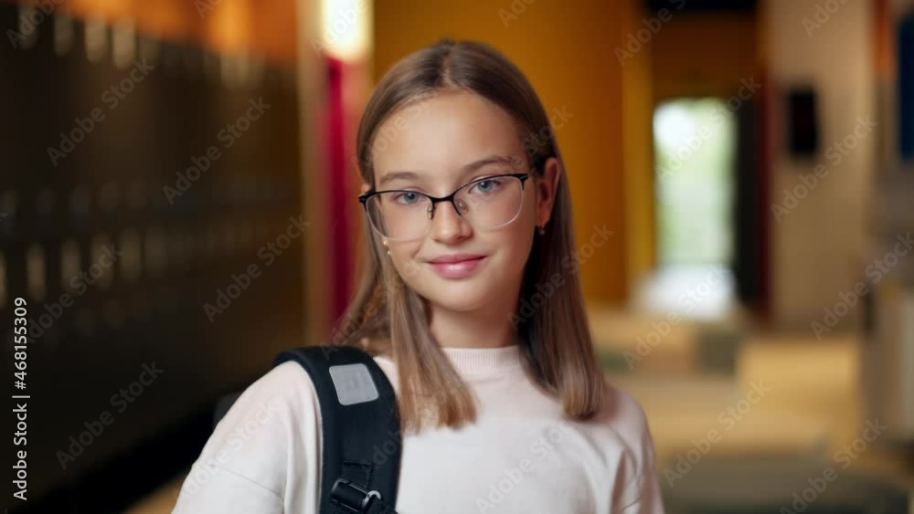 Close-up view of schoolgirl in eyeglasses looking at the camera Close-up view of schoolgirl in eyeglasses looking at the camera