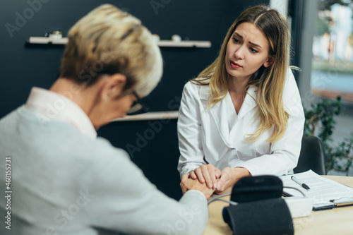 Female doctor in consultation with a senior woman patient