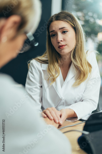 Female doctor in consultation with a senior woman patient