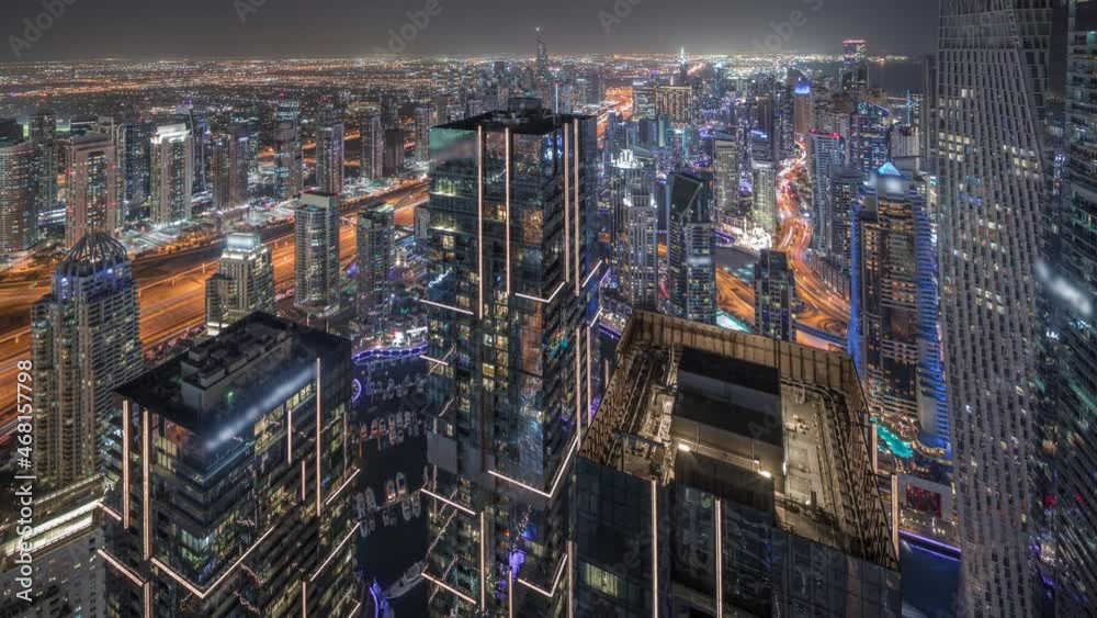 Dubai Marina and JLT district with traffic on highway between skyscrapers aerial night timelapse. Dubai Marina and JLT district with traffic on highway between skyscrapers aerial night timelapse.