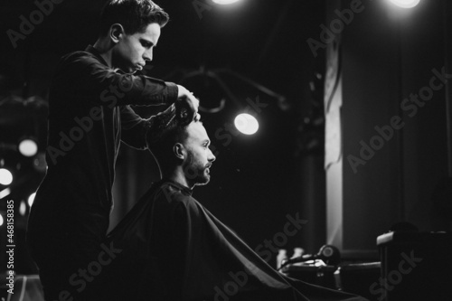 Young man at barbershop trimming hair