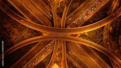 Billede på lærred Aerial drone long exposure night photo of urban elevated road junction and inter