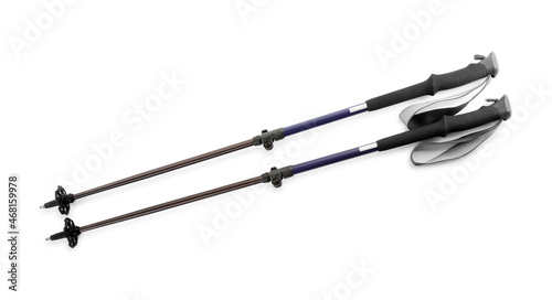 Pair of trekking poles on white background, top view. Camping tourism