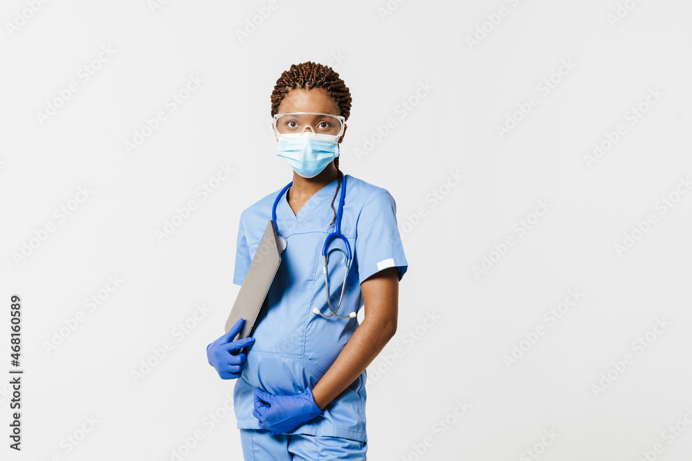Black pregnant doctor in face mask posing with laptop Black pregnant doctor in face mask posing with laptop