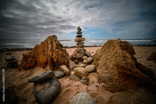 One of many rock cairns among a garden along the coast of Portugal 