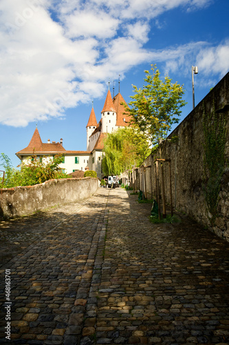 Vertical shot of a brick road and the Thun Castle in the background in Switzerland photo