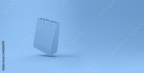 Blue Shopping bag levitating in blue background.