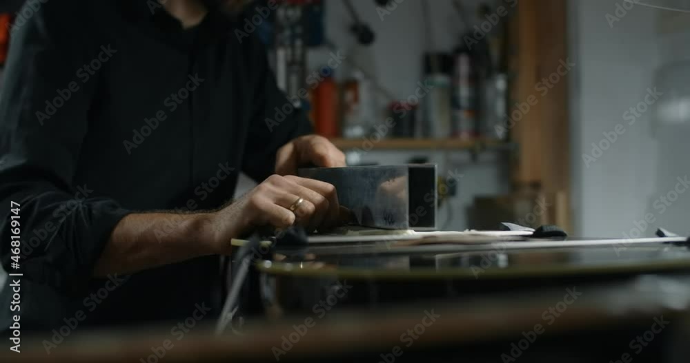 Luthier sands guitar frets at musical instruments repair shop, 4k 60fps 10 bit Luthier sands guitar frets at musical instruments repair shop, 4k 60fps 10 bit