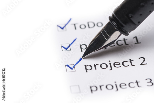 pen with to-do list projects checked off
