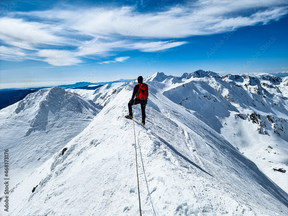 hiker in the snow, Vaiuga Peak, Fagaras Mountains, Romania