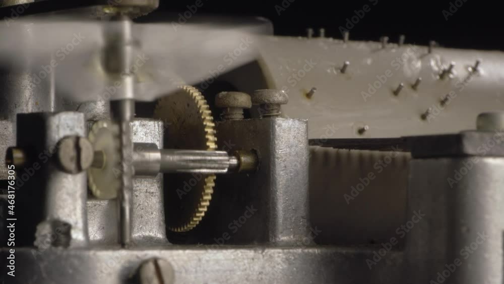 Rotating cogwheels inside the mechanism of an old vintage music box. Macro shot. Rotating cogwheels inside the mechanism of an old vintage music box. Macro shot.