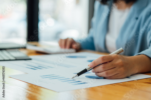 businessman checking financial reports on table