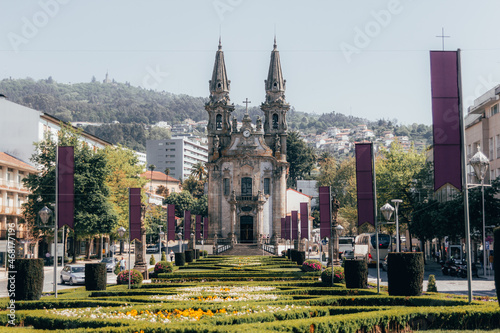 Church with a garden in front and mountains in the background photo