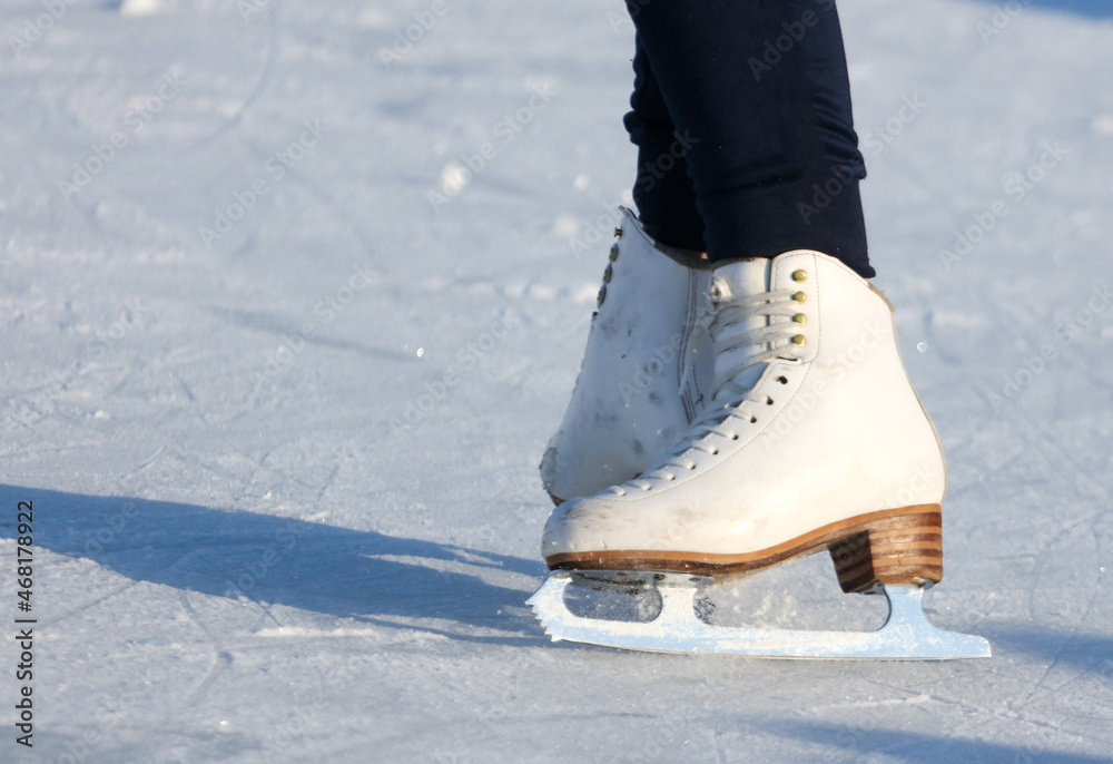 White skates on the legs of the girl White skates on the legs of the girl