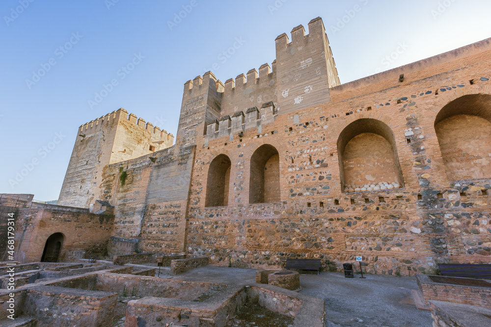 Inside of the Alcazaba with the tower of tribute and the ruins of the military barracks on the foreground
