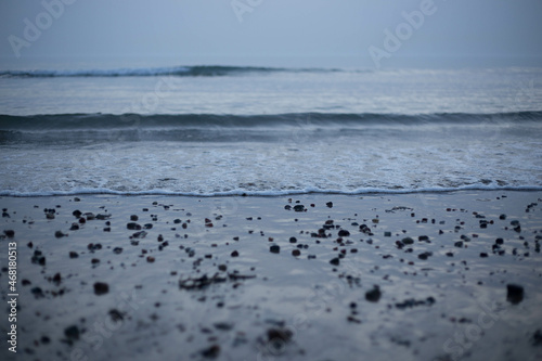 Pebbles on beach with small wave