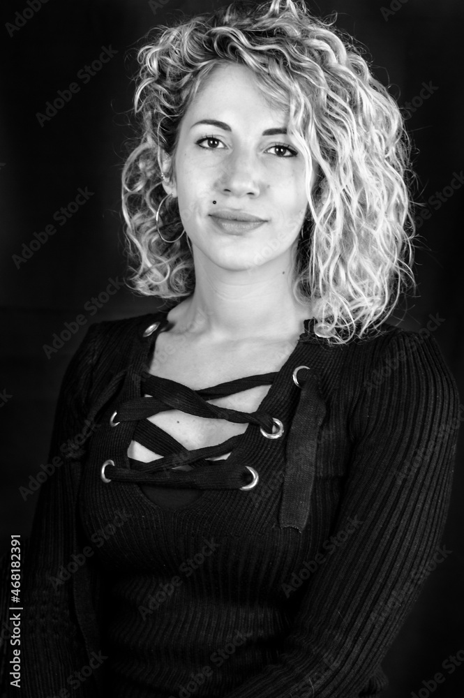 Black and white portrait of a beautiful young woman with blonde and curly hair Black and white portrait of a beautiful young woman with blonde and curly hair