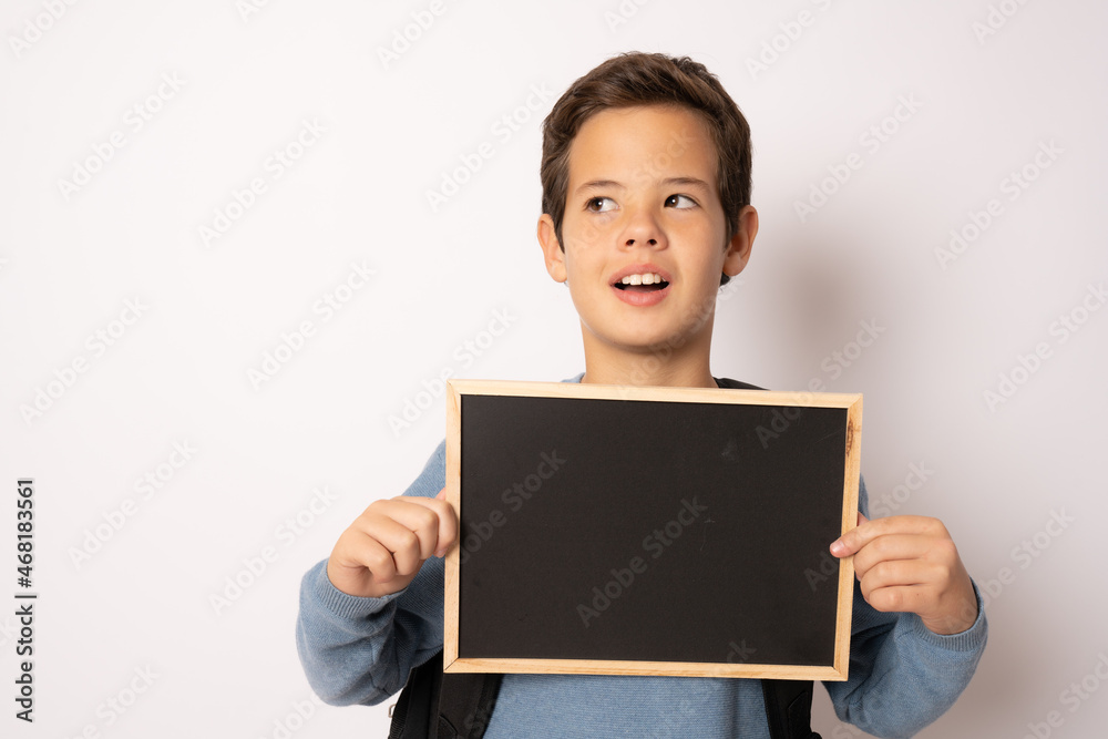 School boy holding a chalk board isolated over white background School boy holding a chalk board isolated over white background