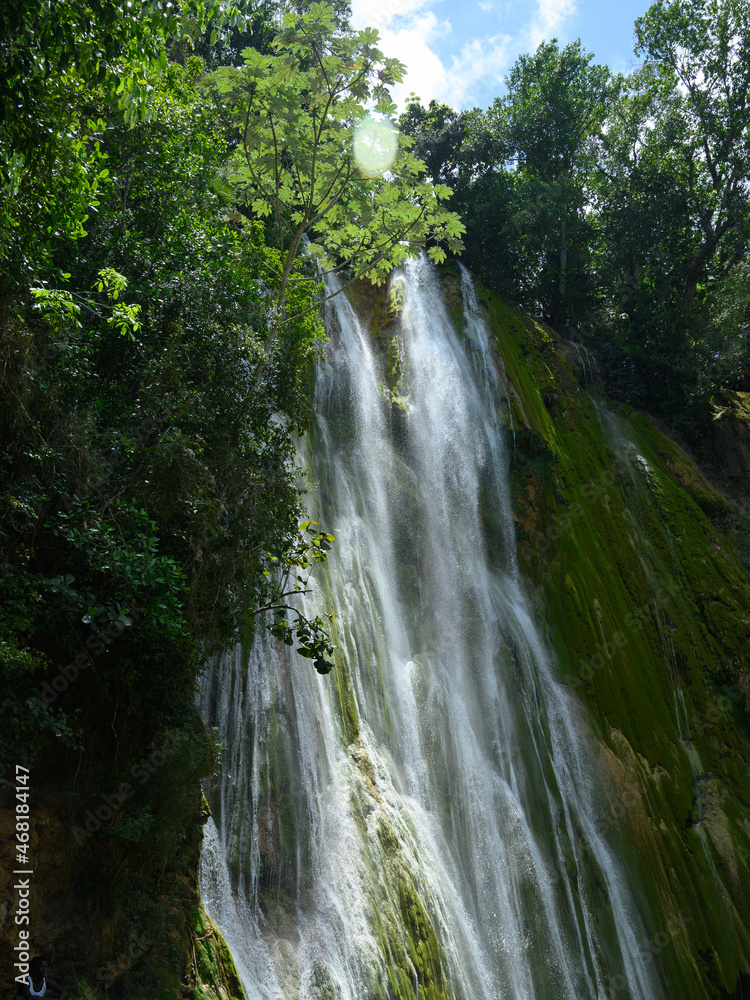 environment cascade in carribbean island pure water. The photo of the waterfall was taken in the Dominican Republic in the rainforest. The picture of the jungle with water impresses with its pristine