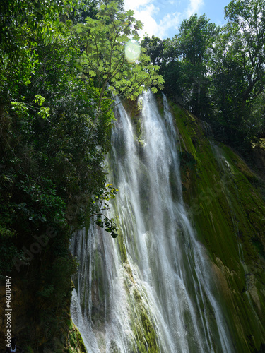 environment cascade in carribbean island pure water. The photo of the waterfall was taken in the Dominican Republic in the rainforest. The picture of the jungle with water impresses with its pristine