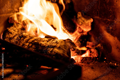 Fire in a hearth with flames surrounding the firewood