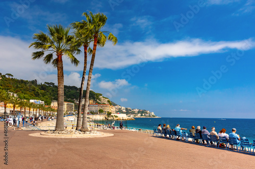 South sidewalk witn blue chairs of Promenade des Anglais in Nice, French Riviera, France photo