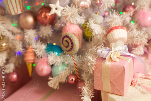 Christmas decor on the tree in light pink colors 