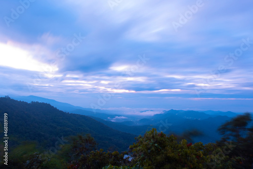 The sun rises on a high mountain with clouds