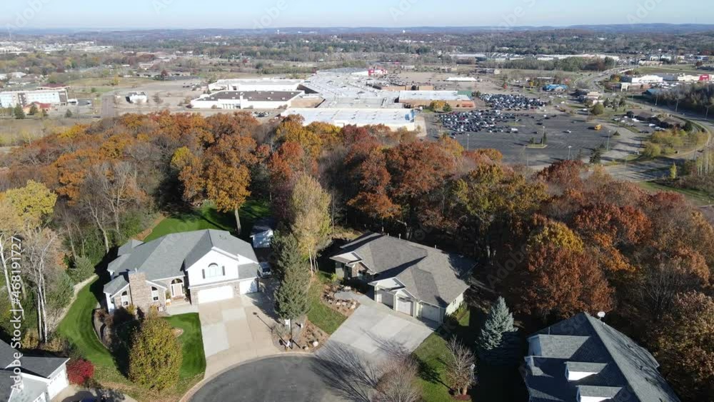 Aerial view of Eau Claire, Wisconsin, residential neighborhood in autumn.  Wide streets with curbs and sidewalks. Large homes and yards.  Park nearby.