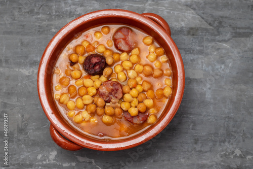 chick pea with smoked sausages and meat in brown pot