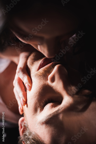 close up view of young couple kissing with closed eyes