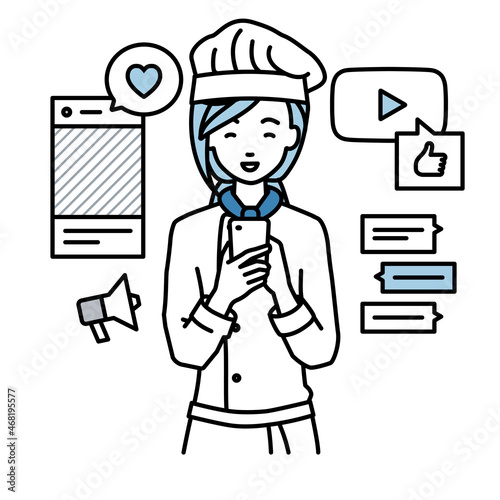 立ってスマートフォンでさまざまなSNSで楽しく交流する調理師の女性
