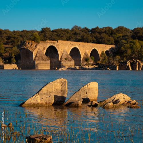 old bridge over the river, The Bridge of Ajuda.  The bridge was constructed between 1520 and 1521, during the reign of King D. Manuel I of Portugal. many of the archways were damaged during flooding. photo