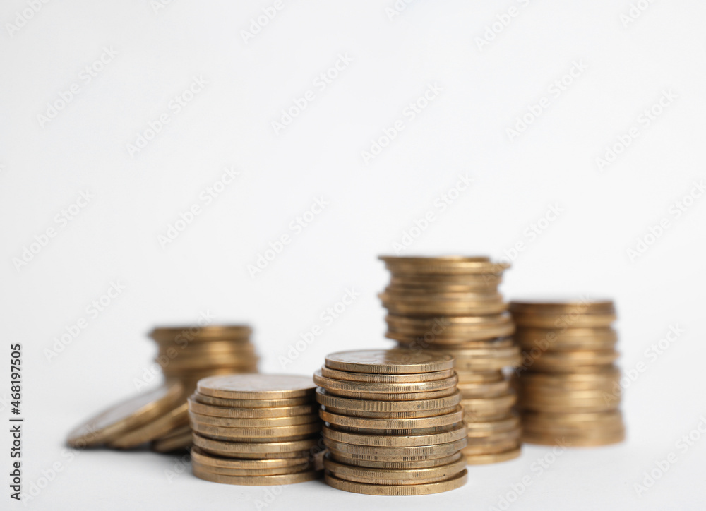 Many Euro coins stacked on white background Many Euro coins stacked on white background