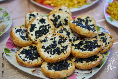 sandwich with caviar,plate with sandwiches and black caviar