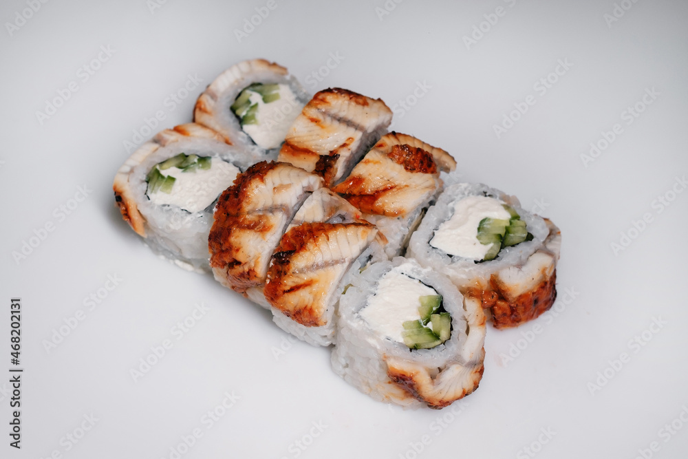 Sushi set with salmon, tuna and cream cheese close-up. Traditional Japanese cuisine side view. Sushi set with salmon, tuna and cream cheese close-up. Traditional Japanese cuisine side view.