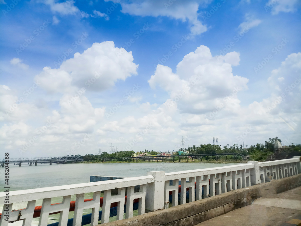 Beautiful landscape image of Mahanadi river of Odisha, with blue sky and white clouds in the background. Nature stock image of Odisha , India with copy space.