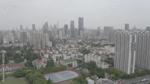 Drone going down in a residential zone in Shanghai, China. Big buildings and financial business skyscrapers Basketball and volleyball courts visible. 